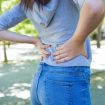 closeup-young-woman-touching-waist-park