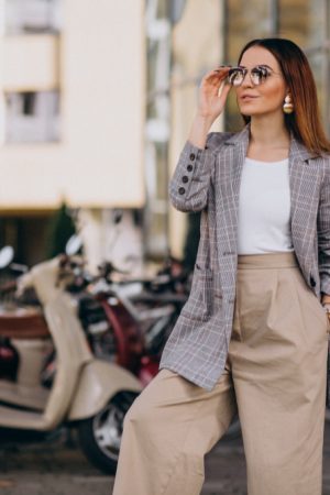 young-woman-suit-standing-by-scooter