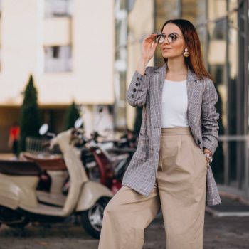 young-woman-suit-standing-by-scooter