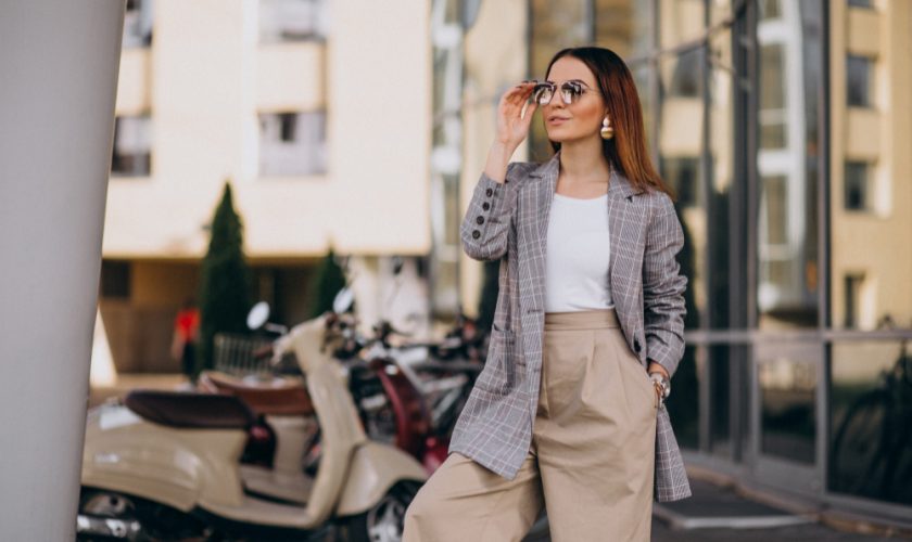 young-woman-suit-standing-by-scooter