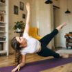 energetic-athletic-young-woman-exercising-indoors-doing-side-plank-pose-which-helps-build-strength-core-arms-legs