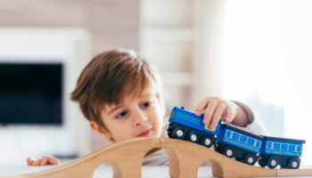 kid-playing-with-toy-train