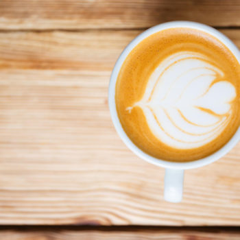 top-view-cup-with-cappucino-wooden-table